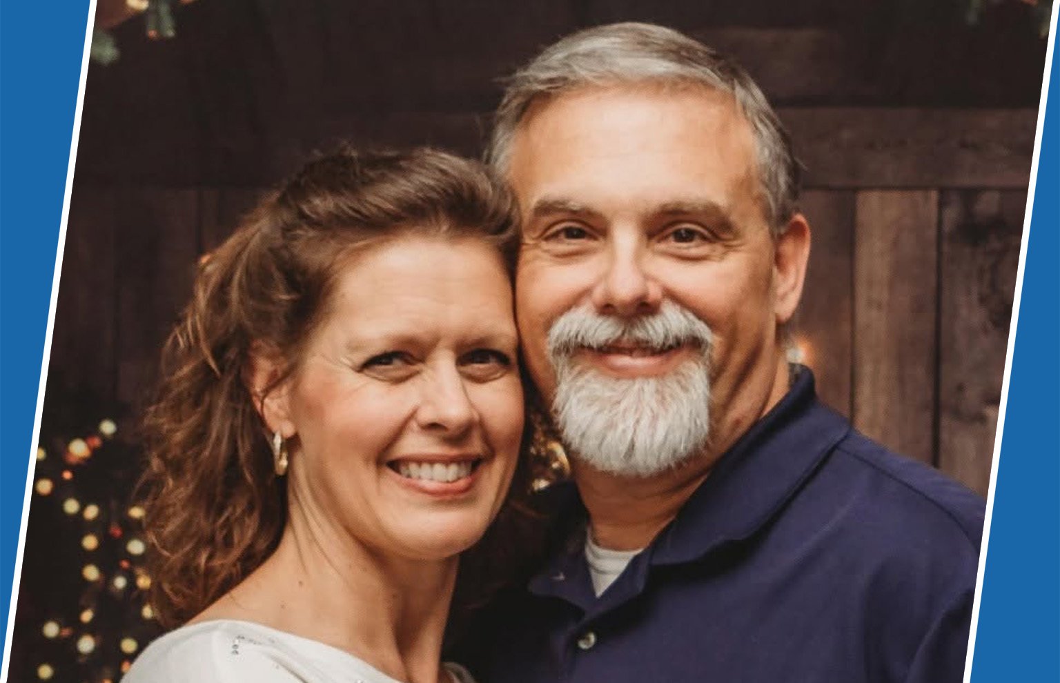 Smiling couple, a woman and a gray-bearded man, posing close together