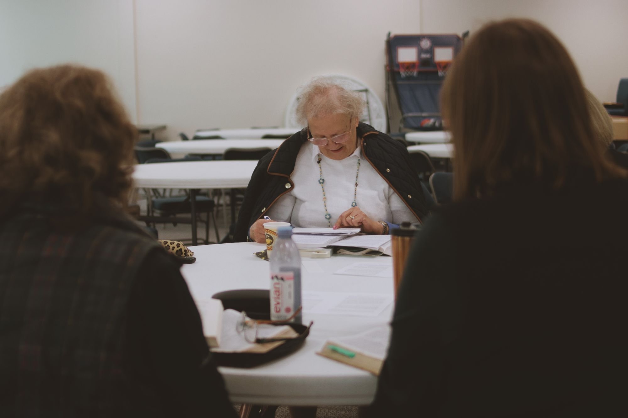 Adults gathered around a table during a class